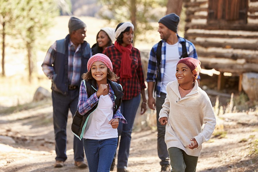 Life and Health Insurance - Multi Generational Family Group On Walk Through Woods In the Fall